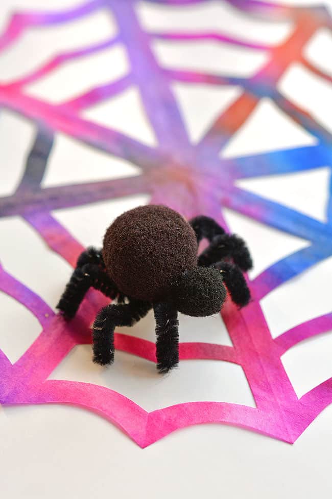 These coffee filter spider webs are SO EASY to make and they look AWESOME! The pipe cleaner and pom pom spider is so simple, but it really makes this Halloween decoration look amazing! This is such a fun Halloween craft for kids and a simple way to make some spooky Halloween decor!