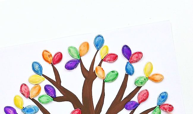 How to Dye Pumpkin Seeds: Easy Craft for Kids Dyed pumpkin seeds glued on a tree template