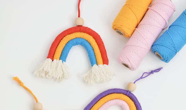 How to make Macrame Rainbow Group of colourful macrame rainbows on a white background
