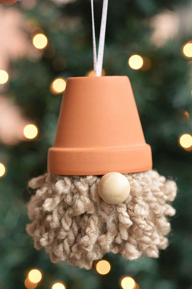Christmas gnomes ornament in front of a Christmas tree
