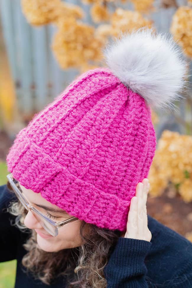 Wearing a pink homemade crochet beanie