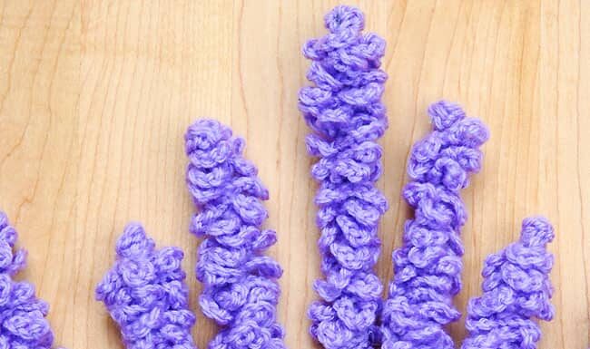 How to Crochet Lavender: Simple DIY Guide Bundle of crochet lavender flowers on a wood background