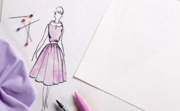 8 Best Fabric Markers for Cotton, Canvas, and T-Shirts in 2026 A hand using a Tulip Dual-Tip Fabric Marker to draw a vibrant floral design on a cotton T-shirt