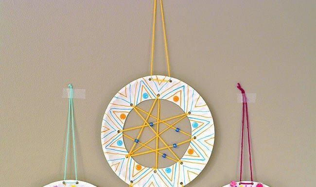 How to Make a Dreamcatcher Three dreamcatchers hanging on a wall