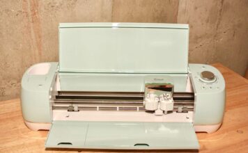 Cricut Explore Air 2 Review: Is It Still Worth It? Cricut Explore Air 2 cutting machine in use with vinyl and a dual tool holder visible