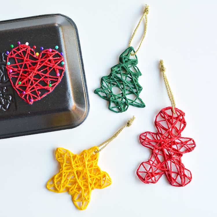 These wrapped yarn ornaments are SO PRETTY and they're so fun to make! Using yarn, glue, sewing pins and styrofoam trays you can make unique and beautiful homemade Christmas ornaments! They look beautiful on the Christmas tree and they make awesome gifts.