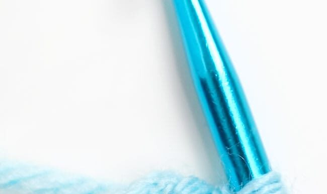 How to Crochet a Magic Circle: Beginner’s Guide Showing a magic circle with single crochet on a crochet hook