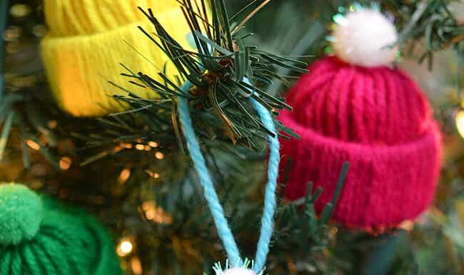 DIY Gnome Ornaments: Fun Holiday Craft Colourful yarn hat ornaments on a Christmas tree