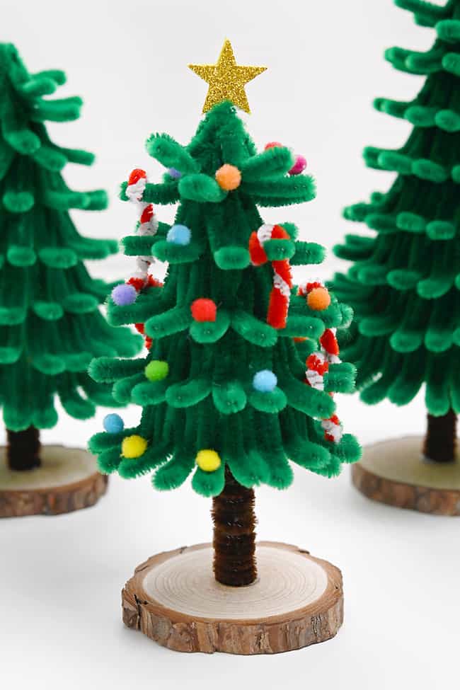 Pipe cleaner Christmas tree decorated with a glitter star topper and pom poms