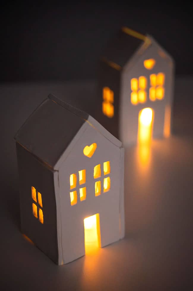 Two clay houses with tealights inside