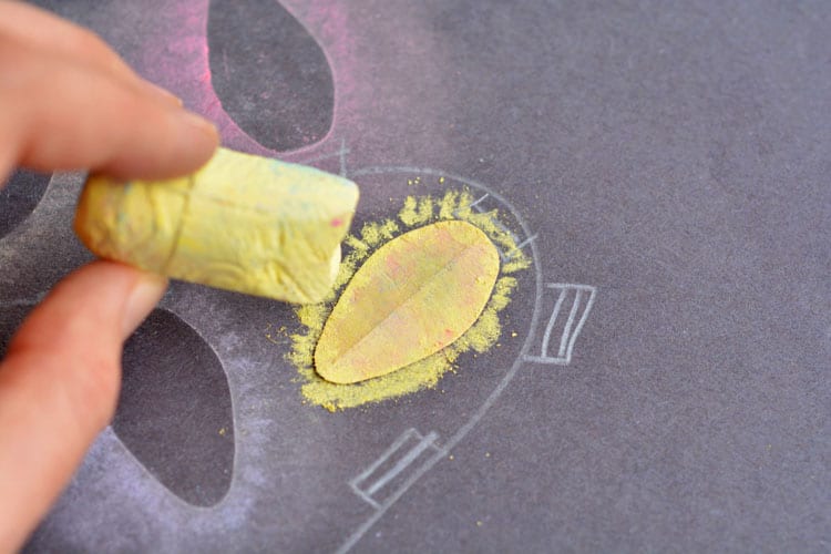 These stenciled sidewalk chalk Christmas lights are so easy to make, and the effect is SO COOL! It looks just like the light bulbs are glowing in the dark!
