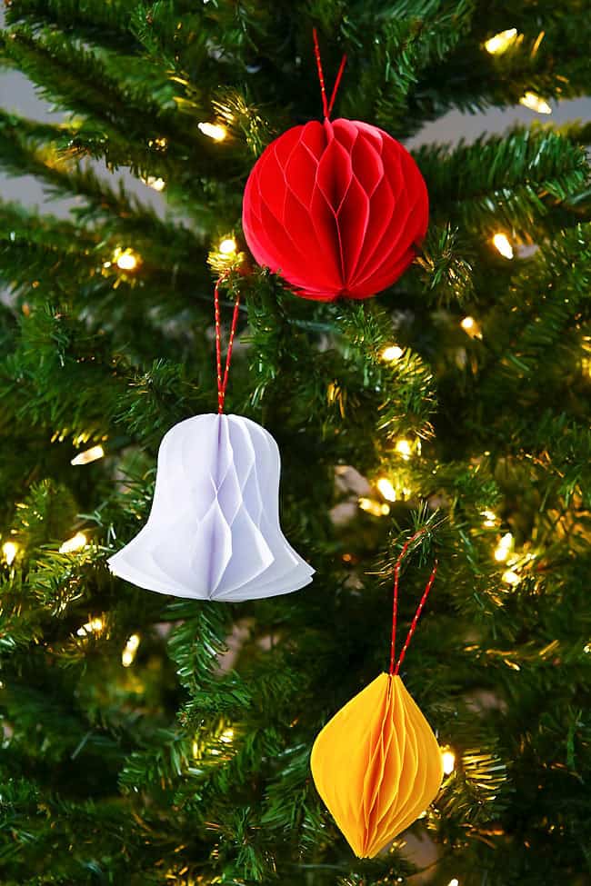Honeycomb paper ornaments hanging in a Christmas tree