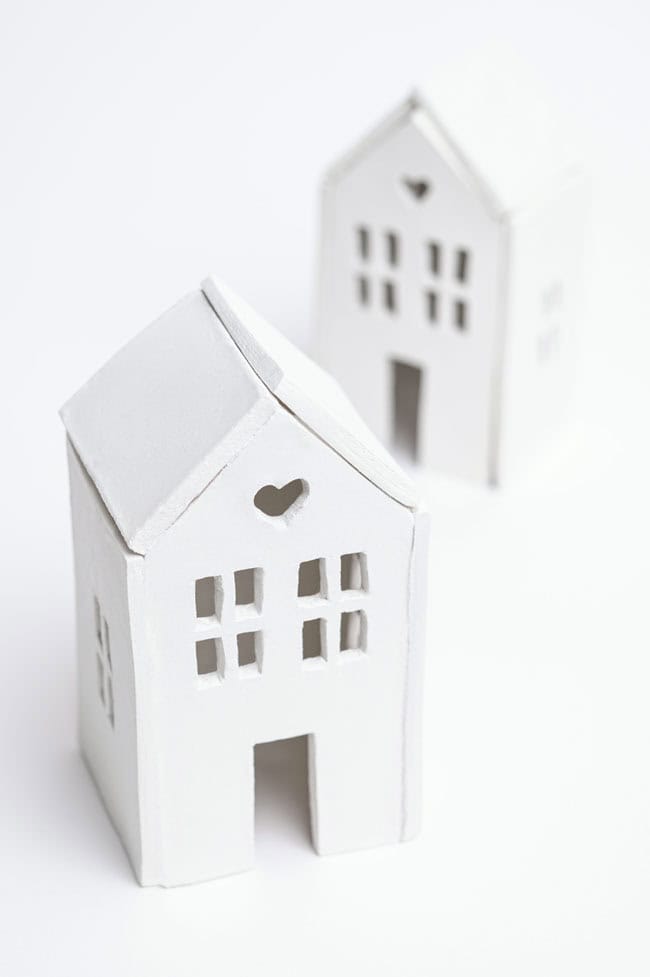 A pair of house candle holders on a white background