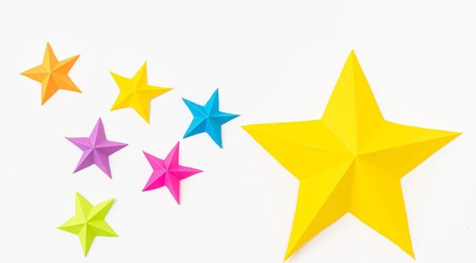 How to Make a Paper Star A large yellow paper star beside a group of small, colourful paper stars