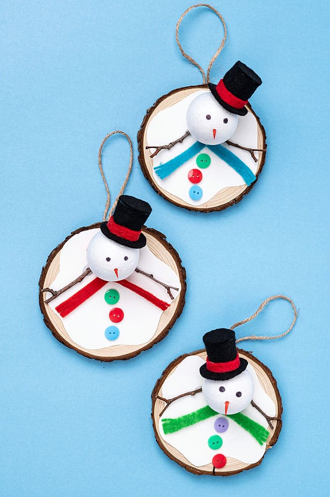 Three melted snowman ornaments with different coloured felt scarves