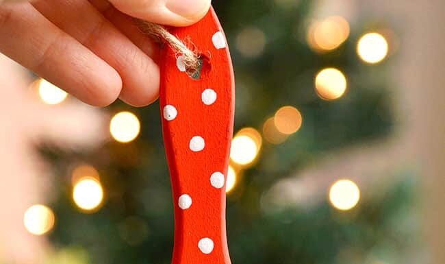 Paint Brush Santa Paint brush Santa ornament held in front of a Christmas tree
