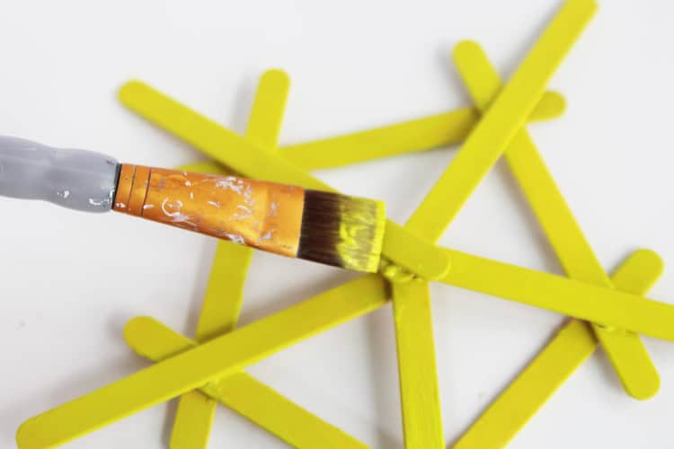 These DIY popsicle stick snowflakes are SO easy to make and look so bright and cheerful!