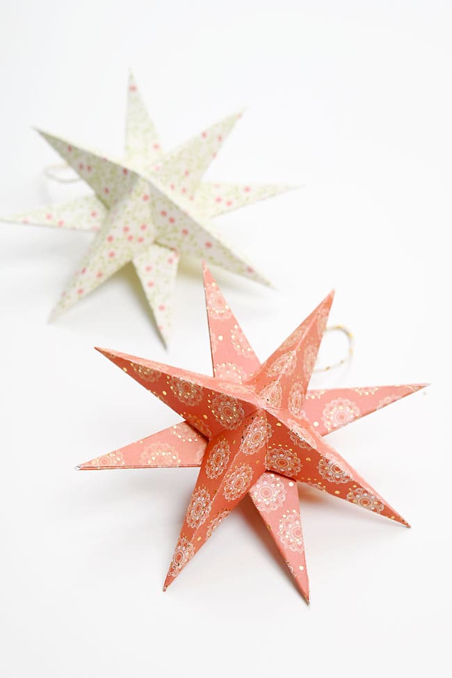 White with pink polka-dot paper star ornament and red with white decorative circles paper star ornament