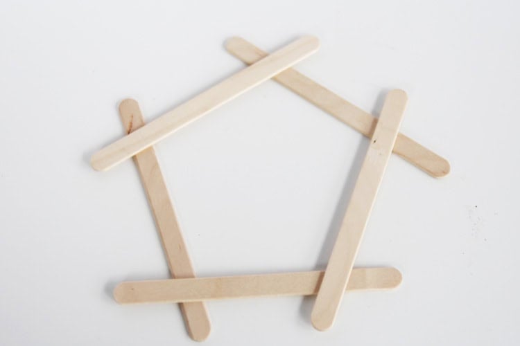 These DIY popsicle stick snowflakes are SO easy to make and look so bright and cheerful!
