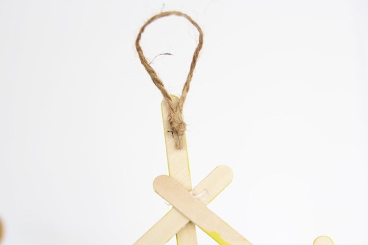 These DIY popsicle stick snowflakes are SO easy to make and look so bright and cheerful!