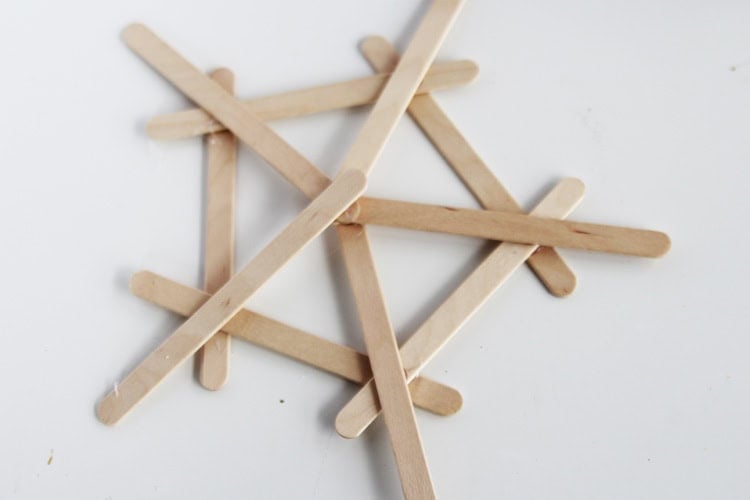 These DIY popsicle stick snowflakes are SO easy to make and look so bright and cheerful!