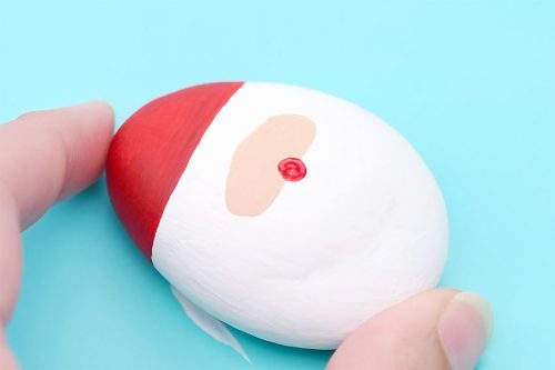 Red, white, and peach painted rock