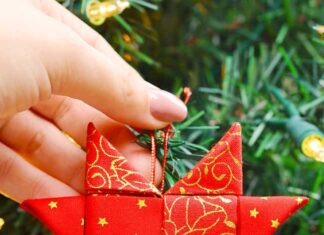 How to Make a Folded Fabric Star Ornament Scandinavian star ornament in front of a Christmas tree