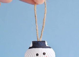 Seashell Snowman Ornaments Seashell snowman ornament hanging in front of a blue background