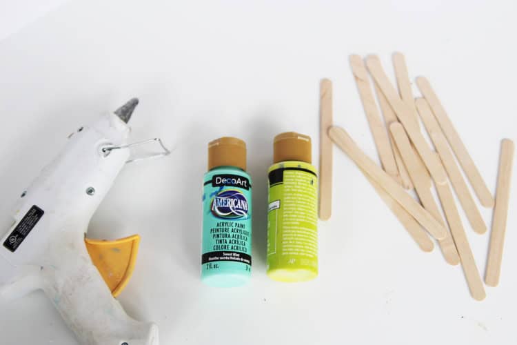 These DIY popsicle stick snowflakes are SO easy to make and look so bright and cheerful!