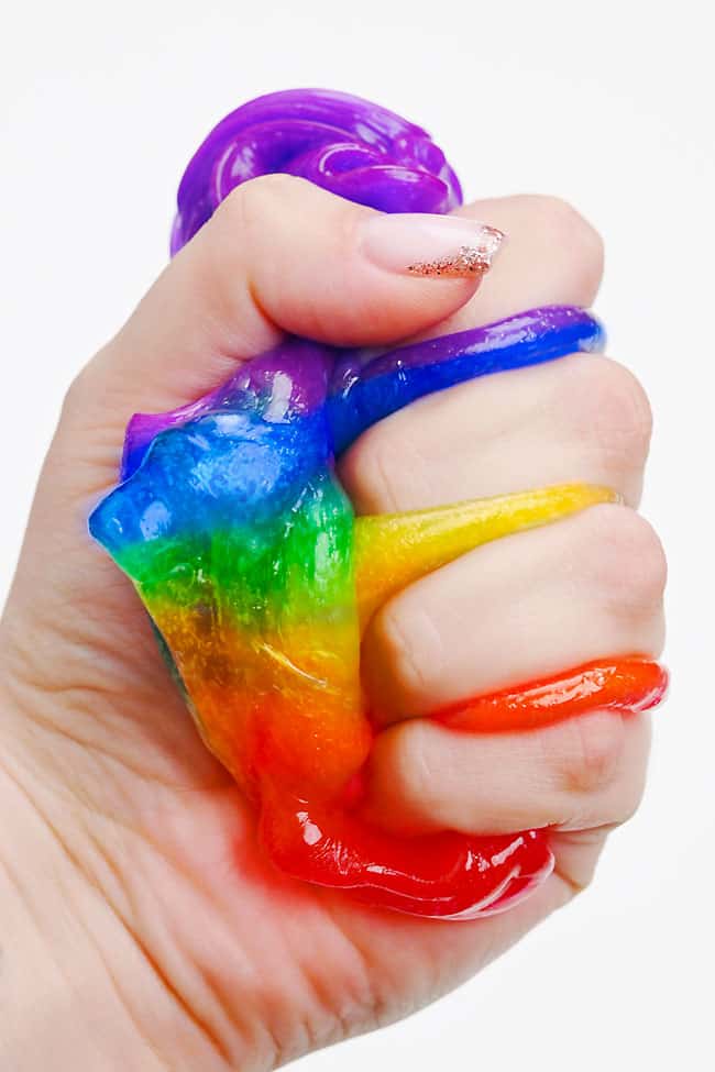 Squishing rainbow slime in a fist