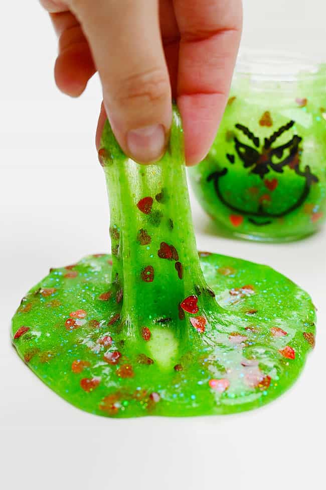 DIY Grinch Slime Heart Confetti Pulling up a stretch of DIY Grinch slime with heart confetti