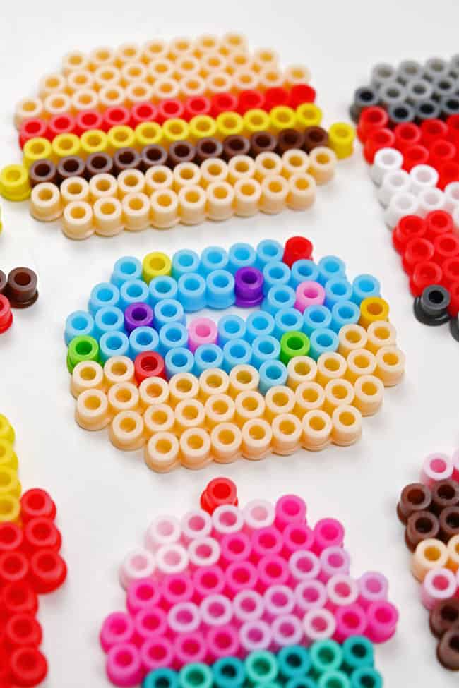 Closeup on the colorful beads making up a donut and other food Perler bead patterns