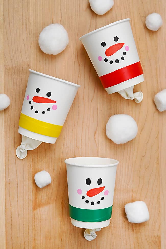 DIY pom pom shooters made with paper cups and balloons