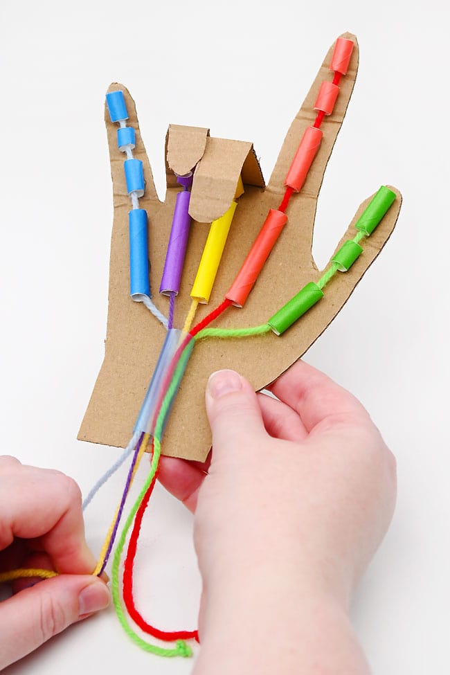 Saying "I love you" in ASL with a cardboard robot hand