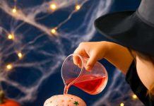 Fizzy Witch Cauldron – Fun Bubbling Brew Experiment for Kids Pouring colored vinegar into a baking soda filled witch cauldron
