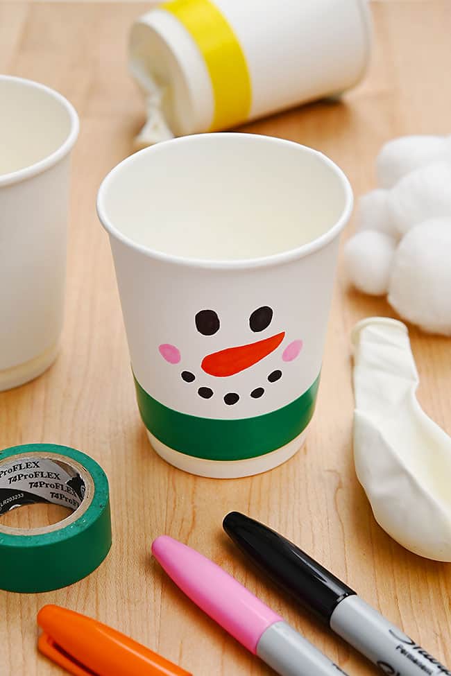 Cute snowman pom pom popper with craft supplies to make one