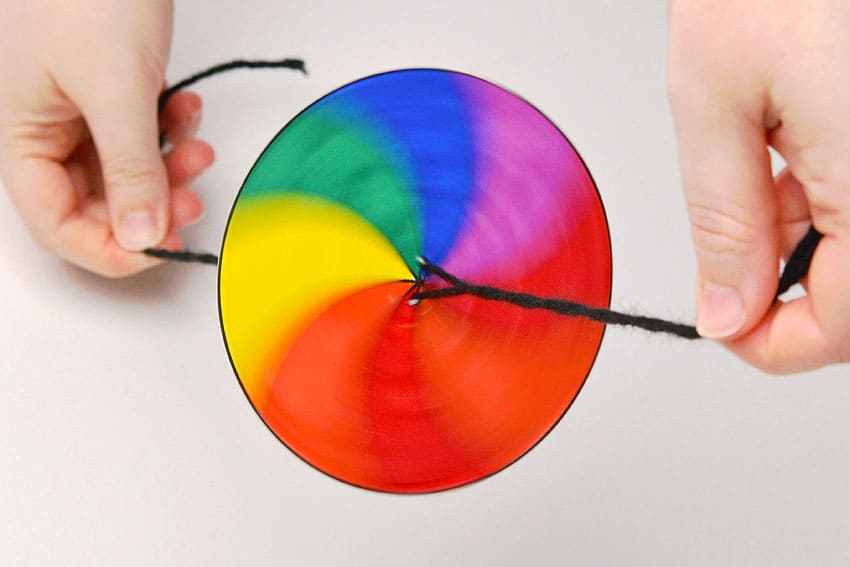 Playing with a colourful string spinner toy